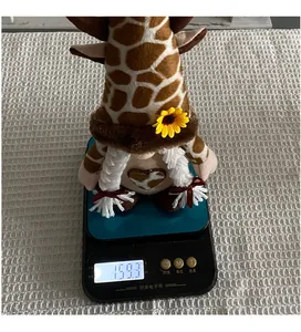 Handcrafted sunflower cow pattern gnome doll weighing 159.3 grams on a digital scale