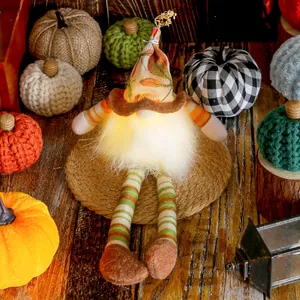 Lighted fall gnome doll with long striped legs and maple leaf hat for harvest festival decor