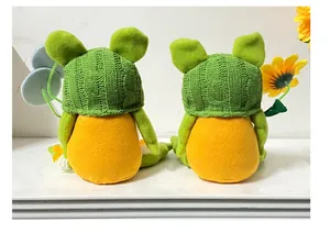 Vista posteriore di due gnomi rana di peluche con cappelli di maglia verdi e un girasole.