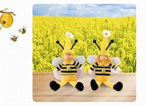 Detailed macro view of handmade bumblebee gnome dolls with wings and knitted daisy hats.