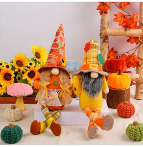Ein Paar handgefertigte gesichtslose Gnome mit Sonnenblumen für herbstliche Deko
