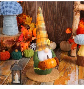 Close-up of a Harvest Festival plush gnome holding a pumpkin in a rustic fall scene