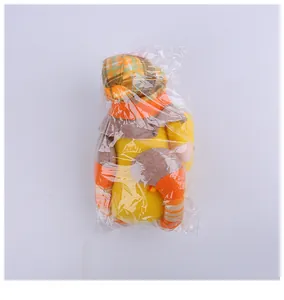 Herbstfest-Zwergenpuppe mit langen Beinen in ihrer originalen transparenten Kunststoffverpackung