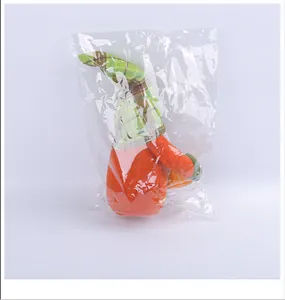 Detailed view of harvest festival gnome plush doll holding a pumpkin in plastic wrap