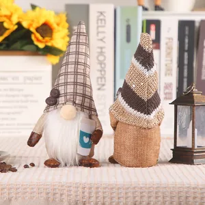 Close-up of handmade coffee themed gnomes with knitted hats and heart coffee cups