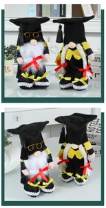 Close-up of a pair of graduation gnome plush dolls with black mortarboards and tassels