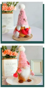Detail shot of plush gnome ornaments with pink knitted hats holding red heart and roses