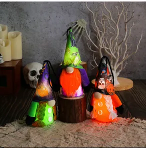 Three glowing Halloween gnome plush ornaments featuring skull and pumpkin patterns.