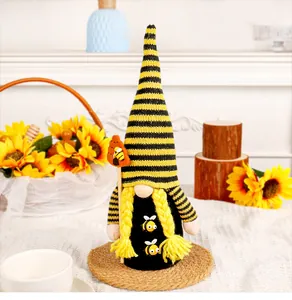 Detailed view of a handmade Bee Festival gnome doll with yellow sunflowers background