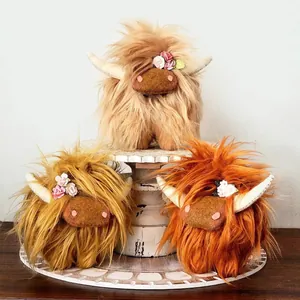 Set of three Highland cow plush toys with long fur and floral accents for farmhouse decor