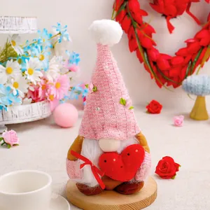 Handmade knitted Mother's Day gnome doll holding a plush red heart for home decoration