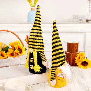 Pair of cute bee festival gnomes with yellow and black striped hats for home decor