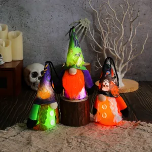 Set of three glowing Halloween gnomes ornaments with skull pumpkin patterns and LED lights.