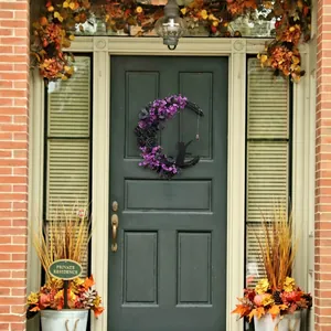 Handmade moon-shaped Halloween wreath featuring black roses and a cat silhouette on a door