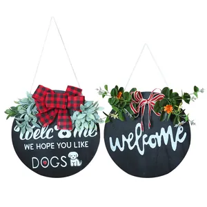 Decorative round wooden welcome signs with plaid bows and artificial eucalyptus