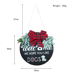 Round wooden welcome door sign with red plaid bow and 'We Hope You Like Dogs' text