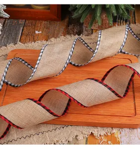 Macro view of rustic Christmas burlap ribbon with decorative red and black plaid edges