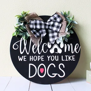 Round wooden welcome door sign with buffalo plaid bow and greenery for dog lovers