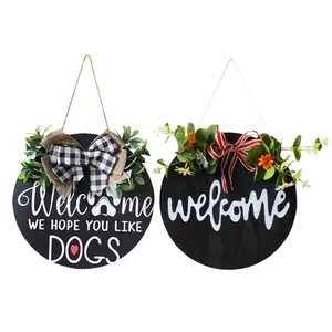 Rustic round wooden welcome door signs featuring floral wreath and decorative buffalo plaid bows