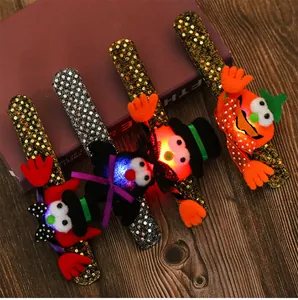 Detail view of four glowing Halloween slap bracelets featuring pumpkin and bat characters.