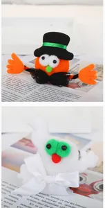Detailed macro shot of festive Halloween pumpkin and white ghost plush character decors