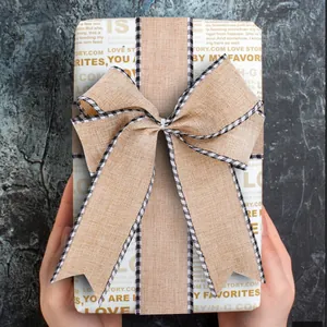 Rustic burlap ribbon with checkered edges tied in a decorative bow for gift wrapping.
