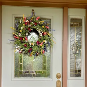 Bunter künstlicher Blumenkranz im Texas-Stil an einer grauen Haustür dekoriert