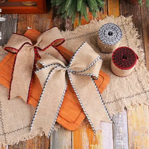 Rustic Christmas burlap ribbon bows and rolls with plaid edges for gift wrapping.