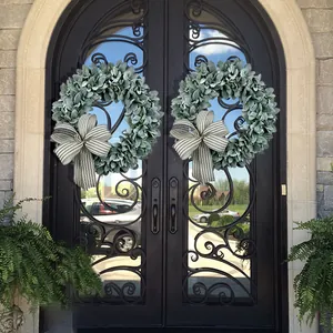 Close-up detail of flocked lamb's ear wreaths with striped bows on elegant doors
