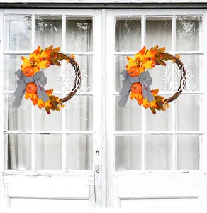 Autumn wreath with maple leaves, pumpkins, and a Hello Fall sign on a white door.
