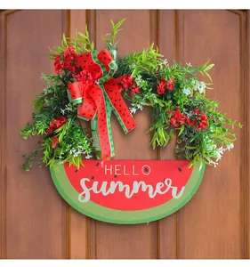 Close-up detail of a vibrant watermelon summer wreath with 'Hello Summer' wooden sign on a door