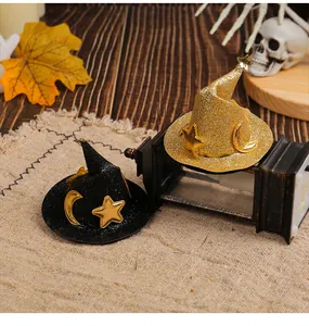 Detailed view of black and gold glittery Halloween witch hat hair accessories on burlap