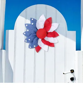Patriotic Independence Day flower wreath with American flag theme on a white door