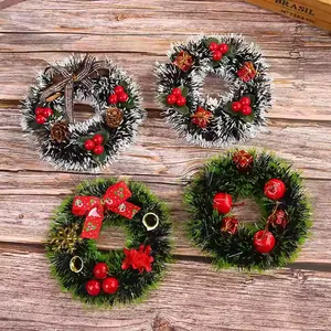 Set of 4 festive mini Christmas wreaths with red berries and tiny ornaments on wood