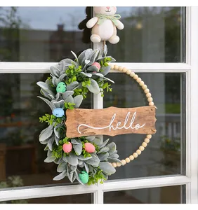 Detail view of Easter wreath with lambs ear leaves, wooden beads, and hello sign