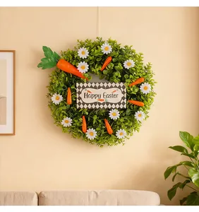 Easter wreath with eucalyptus leaves, daisies and carrots shown on a beige living room wall