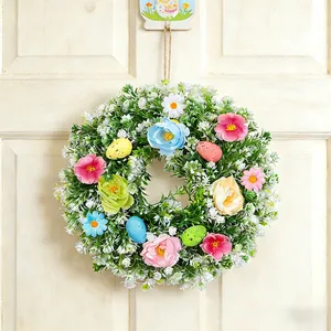 Beautiful Easter wreath featuring spring flowers and colorful speckled eggs for home decoration