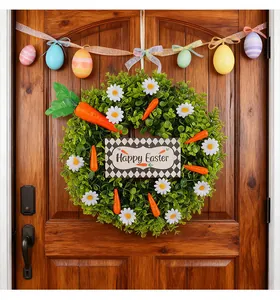 Easter eucalyptus wreath with daisies, carrots and Happy Easter sign on wooden door