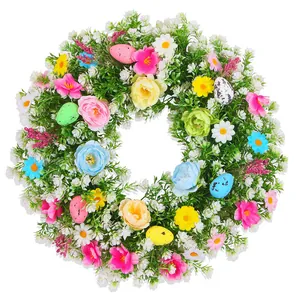 Easter floral wreath with colorful eggs and assorted spring artificial flowers