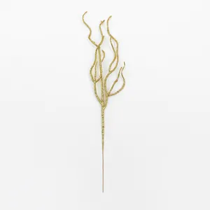 Close-up macro view of a decorative gold glittered artificial twig for Christmas wreaths