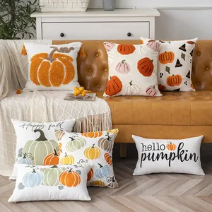 Set of decorative Halloween pumpkin embroidered throw pillows on a brown leather sofa