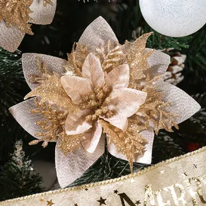 Macro detail of golden glittery artificial poinsettia flower head on Christmas tree