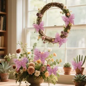 Pink double-layered openwork glitter butterflies decorating a wreath and flowers.