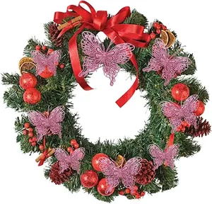 Close-up of large pink glitter hollow butterflies decorating a lush green Christmas wreath.