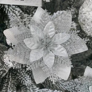 Detailed close-up of a silver glitter poinsettia flower on a frosted Christmas tree