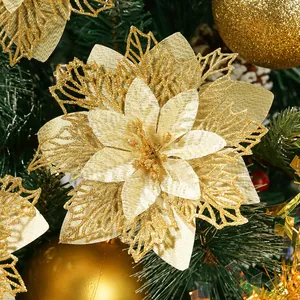 Detail shot of a sparkling gold glitter artificial poinsettia on a Christmas tree