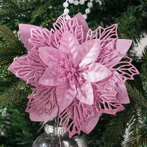 Close-up detail of a pink glitter artificial poinsettia flower on a Christmas tree.