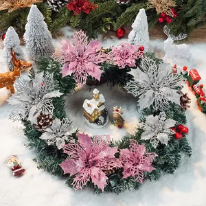 Close-up of festive Christmas wreath with glittery pink and silver poinsettia flowers.