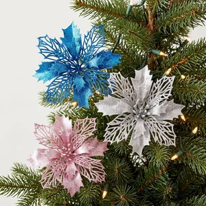 Glittery artificial poinsettia flowers in blue, silver, and pink for Xmas tree decor