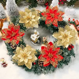 Ghirlanda natalizia con stelle di Natale rosse e oro glitterate su fondo innevato
